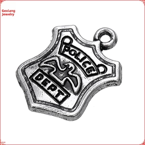 Macro detail of vintage silver police badge pendant with eagle relief and shield shape
