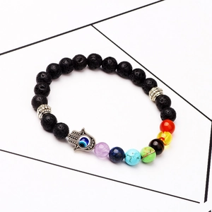 Lava stone chakra bracelet featuring colorful beads and a silver Hamsa hand charm
