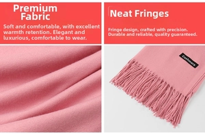 Detail view of pink cashmere scarf featuring soft texture, fringe trim, and black label