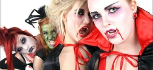 Halloween vampire cloaks and zombie makeup with fangs for spooky party roleplay