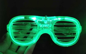 Detail of green LED shutter glasses glowing in the dark for party festivals and events