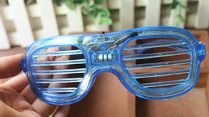 Close-up of blue LED shutter glasses showing battery box and internal wiring details