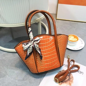 Chic orange crocodile pattern tote bag with decorative H scarf and shoulder strap