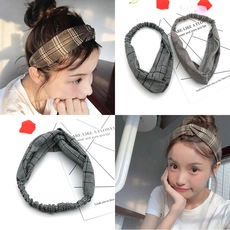 Detailed view of elastic checkered headbands in brown and gray with soft fabric texture