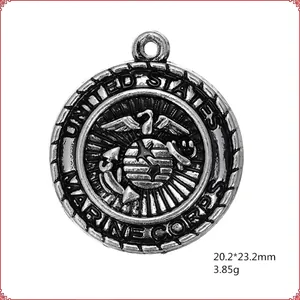 Antique silver United States Marine Corps round pendant charm with eagle globe and anchor logo
