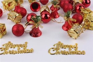 Detail of red glitter baubles, golden bells, and Merry Christmas sign set