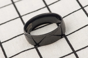 Detailed macro view of 8mm black tungsten carbide ring band with inner engraving