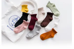 Detailed flat lay of multi-color cotton socks with decorative ruffled lettuce edges