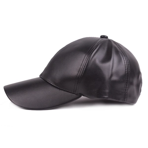 Detail view of smooth black faux leather texture on a six-panel baseball cap side