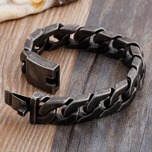 Retro style men's thick cuban chain bracelet in vintage silver finish on wood background