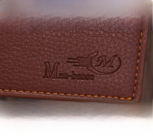 Close-up of brown lychee grain PU leather wallet with orange stitching and embossed logo