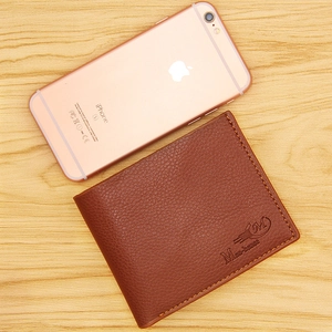 Mens classic brown bifold wallet with lychee pattern texture on wooden desktop