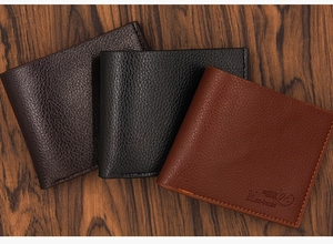 Close-up of three men's bifold wallets in litchi texture black and brown PU leather