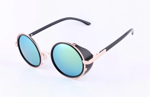 Detail of steampunk round sunglasses with gold metal frame and gold-green mirrored lenses