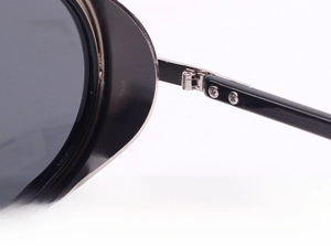 Macro shot of double screw metal hinge on high-gloss black punk steam sunglasses