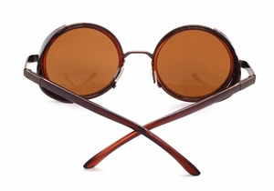 Detail view of steampunk round sunglasses featuring amber lenses and metal side shields