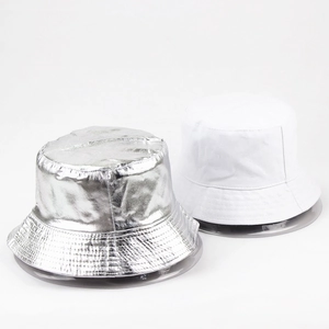 Dual-sided bucket hat detail showing metallic silver texture and plain white fabric contrast