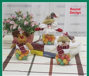 Detail of round Christmas candy jars with Santa, reindeer and snowman plush toppers