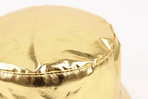 Close-up of metallic gold bucket hat featuring premium fabric texture and precise stitching