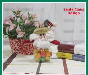 Detail of Christmas Santa Claus candy jar with plaid hat and transparent round container