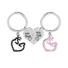Close-up of heart-shaped couple keychains with Her Buck and His Doe engravings