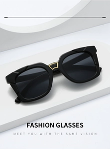 Detailed close-up of fashion square sunglasses with gold fan-shaped bridge accent