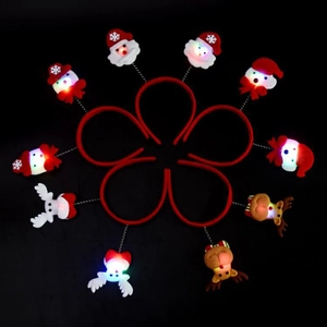 Flat lay of eight glowing Christmas headbands with LED Reindeer and Santa designs