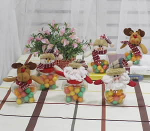 Detail of Christmas candy jars featuring plush Santa, snowman, and reindeer figures