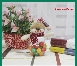 Macro detail of snowman Christmas candy jar with red plaid hat and colorful sweets