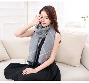 Detail of pink geometric plaid pattern on a soft gray cashmere-feel winter scarf for women