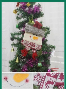 Detail of a plush snowman Christmas stocking with a 3D nose and knit scarf on a tree