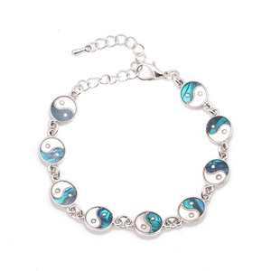 Silver Tai Chi Yin Yang bracelet with colorful abalone shell inlays on white background