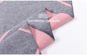 Close-up of fine knit texture and neat overlock stitching on pink and grey scarf