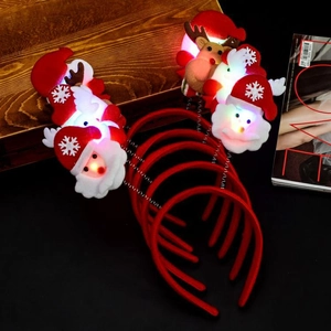 Close-up of glowing LED Christmas headbands with Santa Claus and reindeer designs