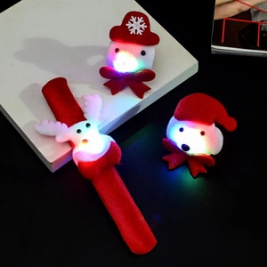 Close-up of glowing plush Christmas Reindeer slap bracelet and mini Snowman decorations