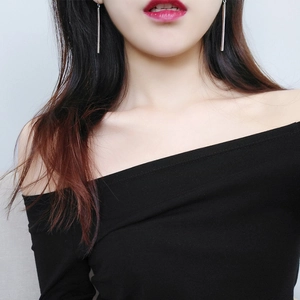 Close-up of elegant long silver bar drop earrings worn by a model in a minimalist style
