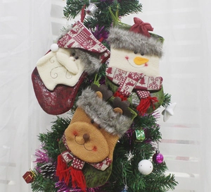 Hanging Christmas stockings set with Santa, Snowman and Reindeer characters on a tree