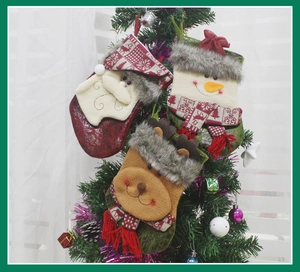 Three medium Christmas stockings with 3D Santa, Snowman, and Reindeer hanging on a tree