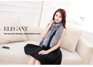 Close-up of elegant grey and pink checkered knit scarf shawl with soft texture detail