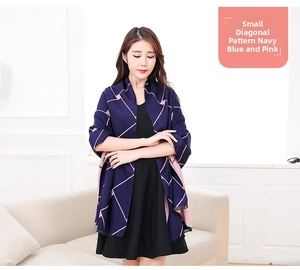 Detail view of the soft navy and pink plaid pattern with delicate black fringed edges