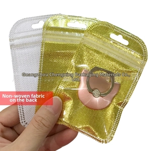 Detail showing self-sealing gold packaging bag with non-woven fabric back and clear window