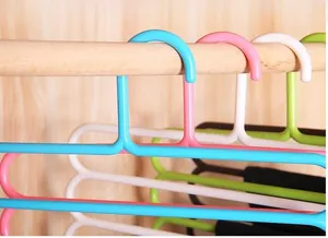 Detail view of colorful 5-tier S-shaped plastic hangers for space-saving pants storage