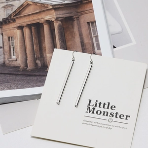 Detailed view of silver long bar dangle earrings on a minimalist display card