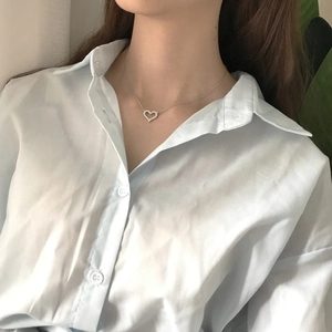 Close-up of 925 sterling silver heart pendant necklace with zircons on model neck