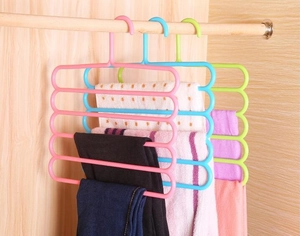 Space-saving 5-tier S-type pants hanger showing blue and green colors in a wooden closet