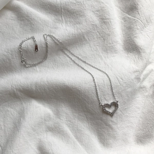 Detailed close-up of S925 sterling silver heart necklace with sparkling zircon pavé
