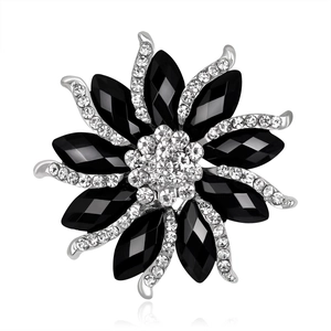 Elegant floral brooch with black faceted gems and sparkling crystals on silver base