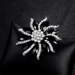 Classic floral brooch with black faceted gemstones and clear crystals on silver metal
