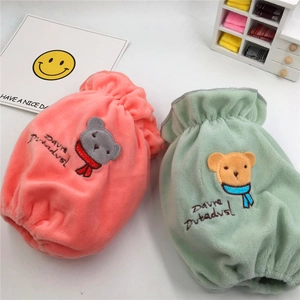 Flat lay of pink and mint green plush pouches with cute bear embroidery and text
