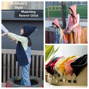 Close-up of thick knitted hooded scarves with pom-poms for kids and adults in various colors